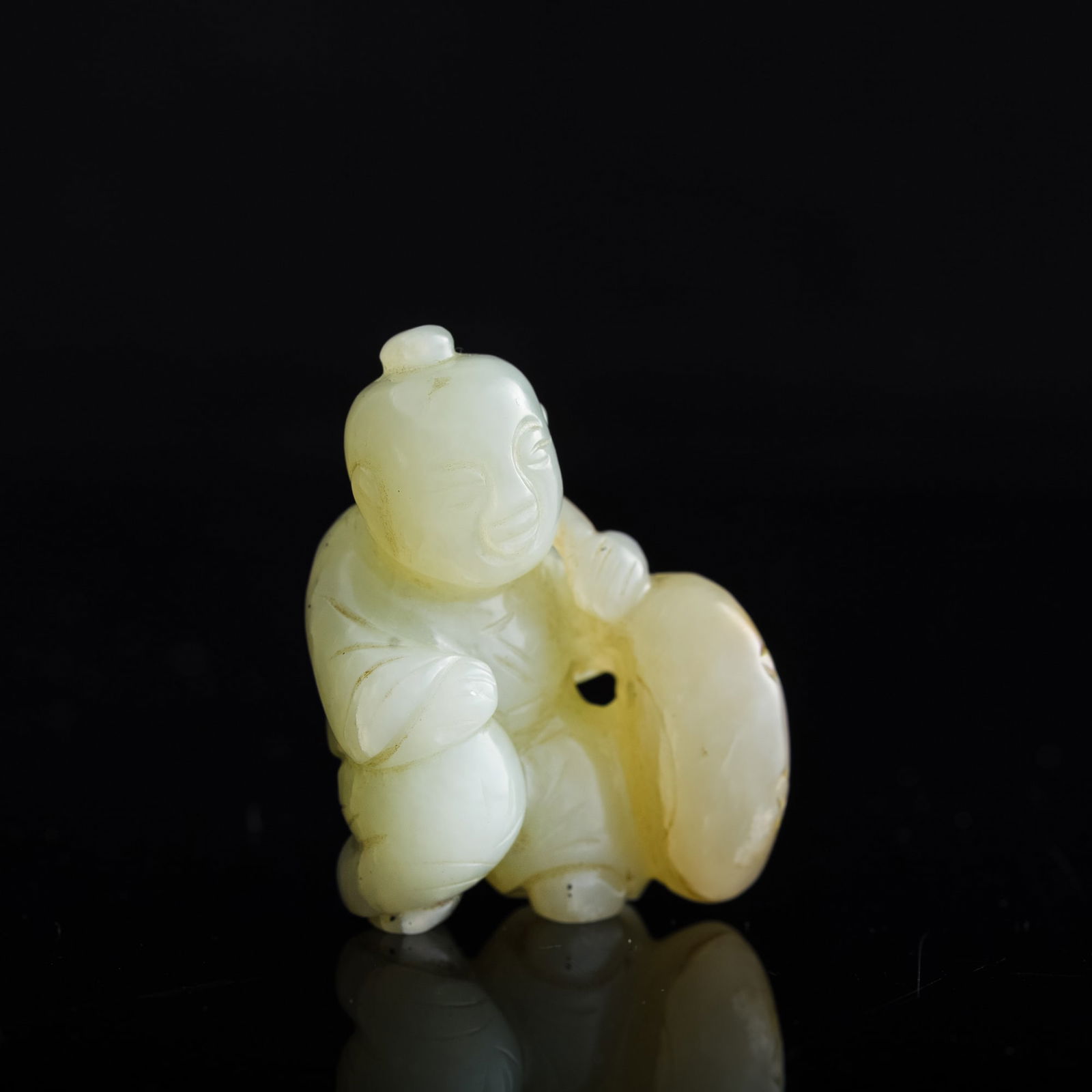 A Chinese carved jade 'boy' pendant, 19th century (1 of 7)