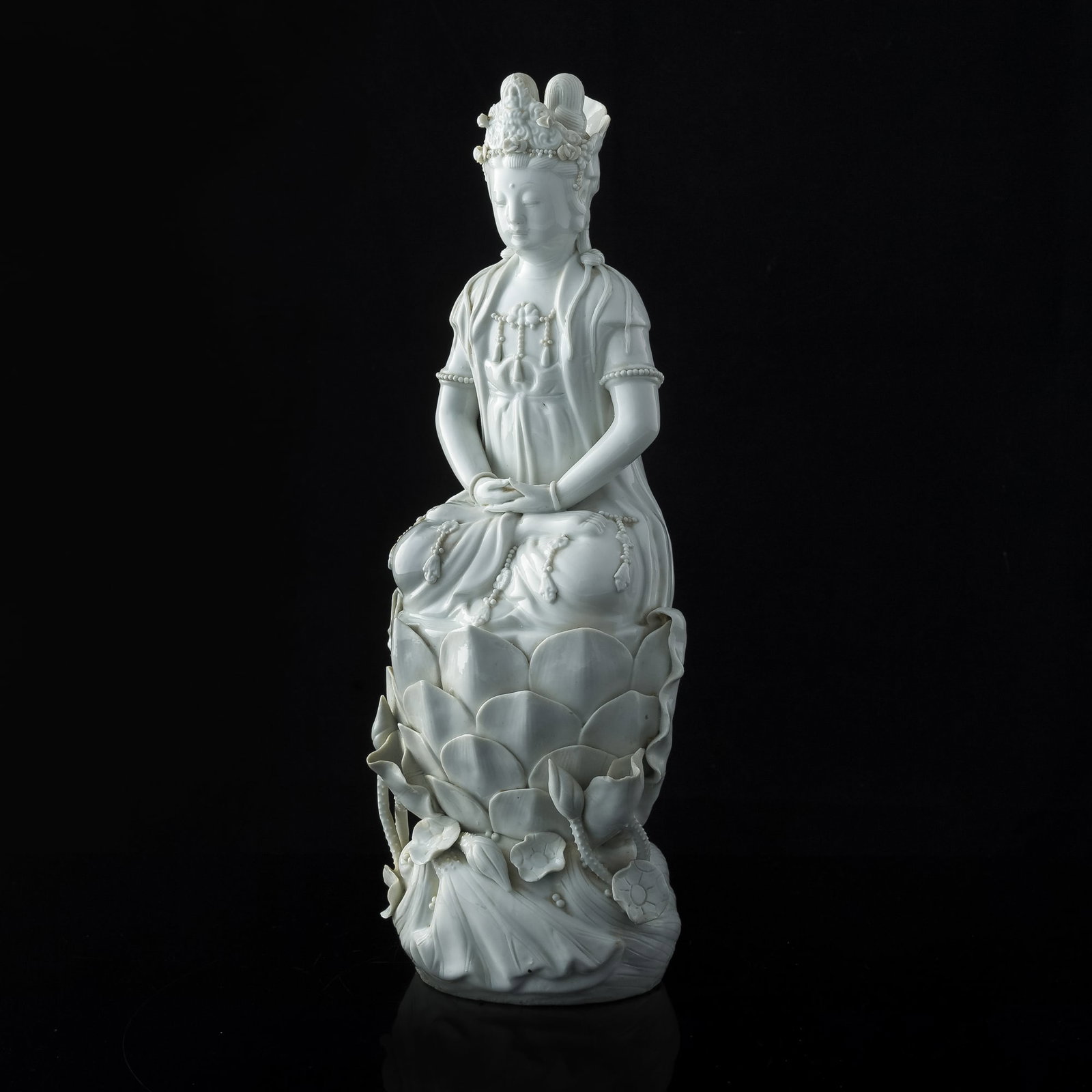A Chinese Dehua blanc-de-chine Guanyin statue, 19th century: A Chinese Dehua blanc-de-chine Guanyin statue 19th century H: 14 3/8, W: 5 1/2, D: 4 1/2 in. H: 36.51, W: 13.97, D: 11.43 cm. Provenance: Private collection, Middletown, Rhode Island.