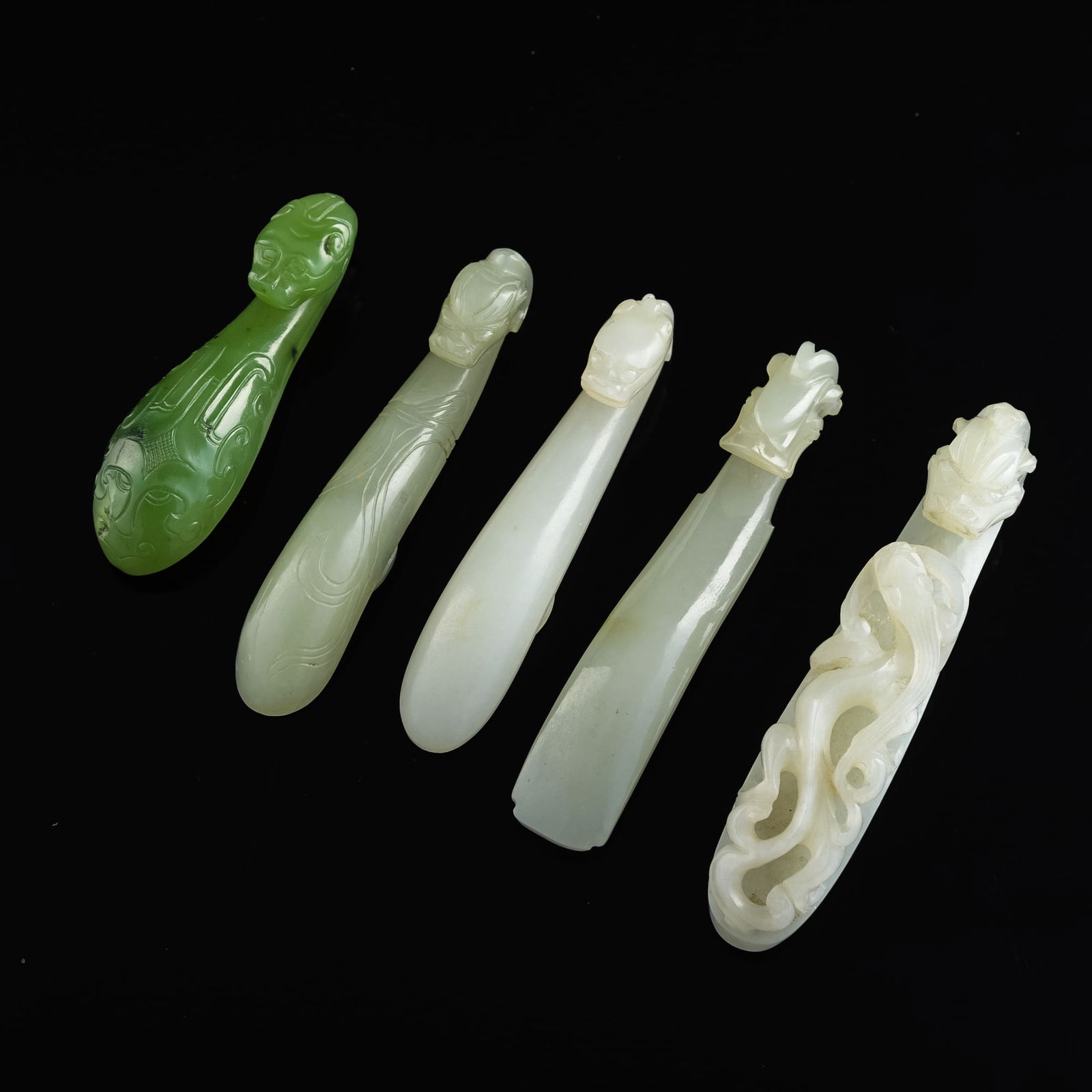 Five Chinese carved jade dragon hooks, 18th century or earlier (1 of 9)