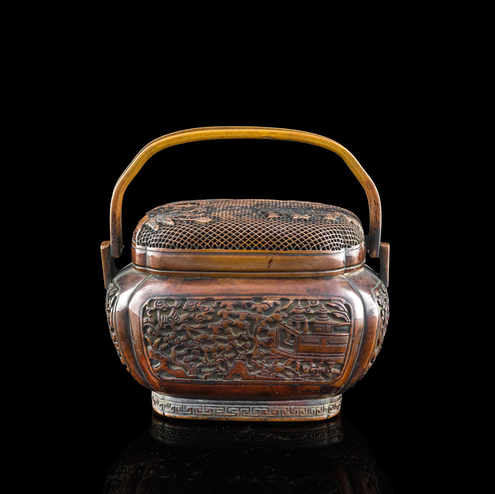 A Chinese bronze hand warmer, by Wang Chenchang (Chinese, Ming dynasty): A Chinese bronze hand warmer by Wang Chenchang (Chinese, Ming dynasty) Decorated with figures in a pavilion amongst a natural setting. With 'Wang Chenchang Zhi' four-character mark to underside. H: 6
