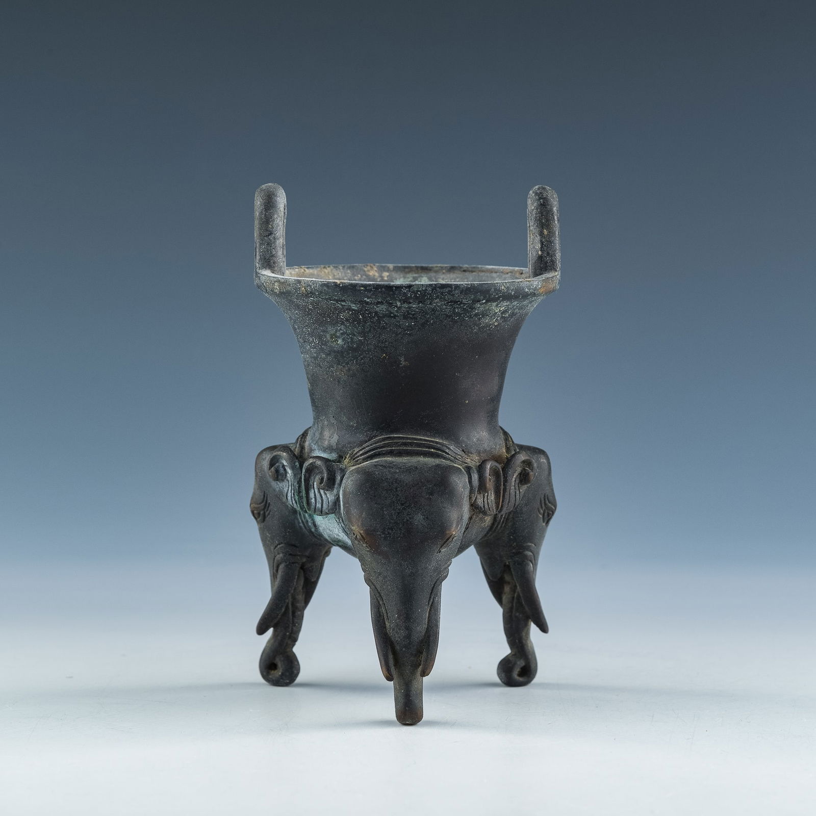 A Chinese bronze elephant trunk-footed tripod censer, Ming dynasty (1 of 9)