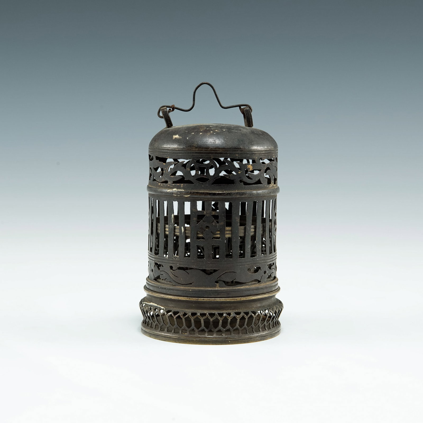 A Chinese bronze incense burner, 18th/19th century: A Chinese bronze incense burner 18th/19th century Comprised of two pieces. The cover with geometric lucky coins, flowers, and chilong motifs, the base with Shou medallions. Previous gallery sticker to