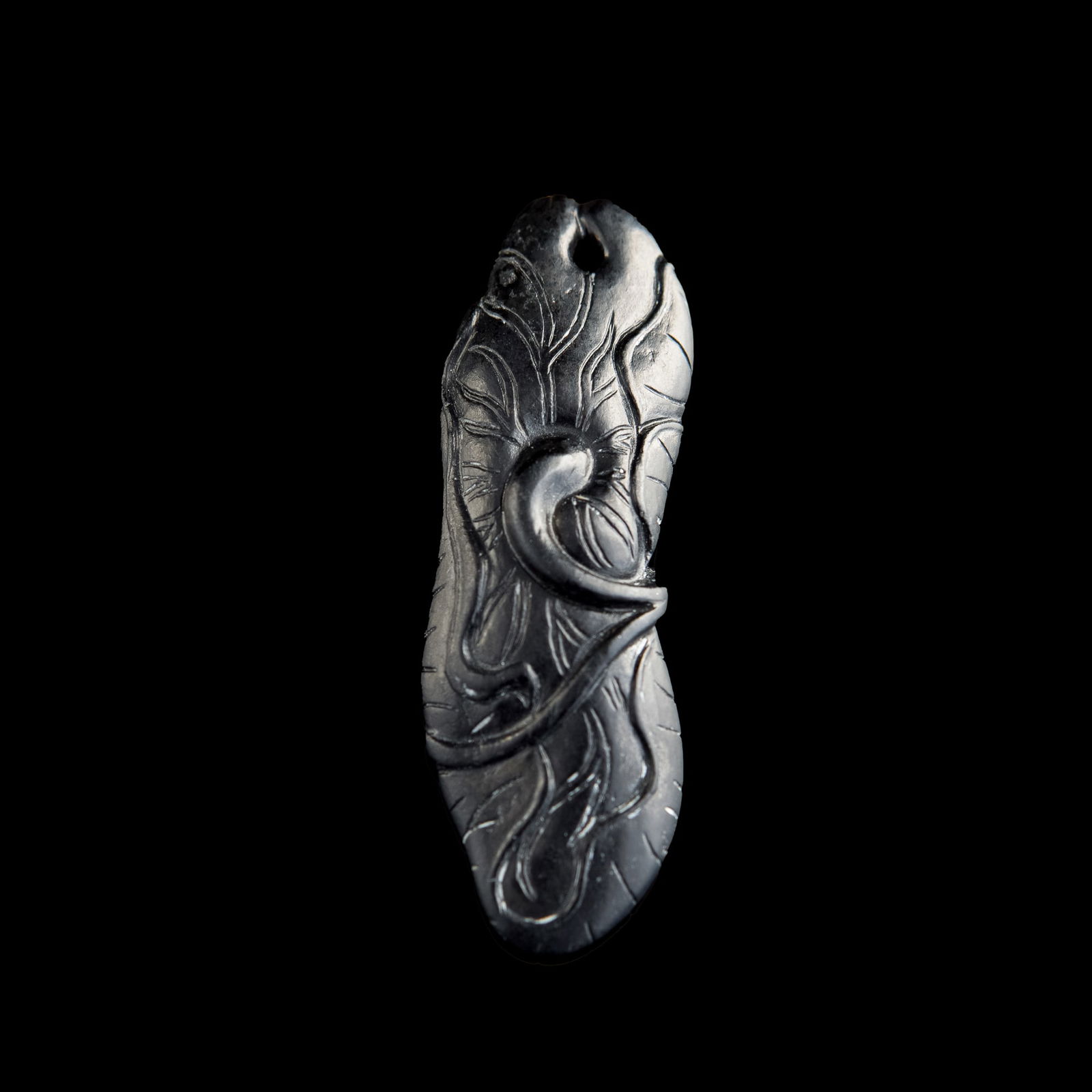A Chinese carved black and white jade 'lotus' toggle, 18th century (1 of 5)