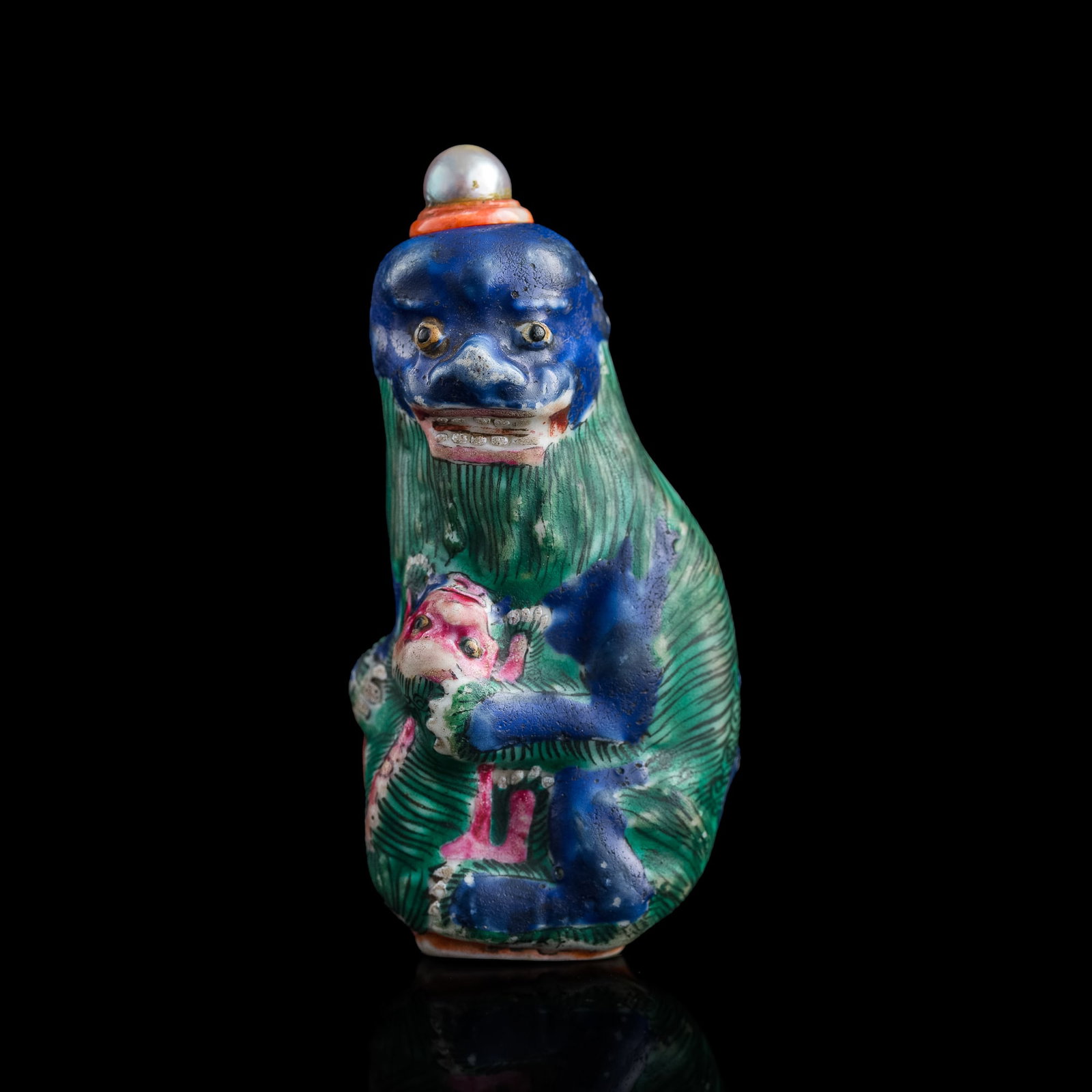 A Chinese molded famille rose lion-form porcelain snuff bottle, 19th century: A Chinese molded famille rose lion-form porcelain snuff bottle 19th century H: 3, W: 1 5/8, D: 1 3/8 in. (H: 7.62, W: 4.13, D: 3.49 cm.) Provenance: Private collection, Cleveland, Ohio. The items in t