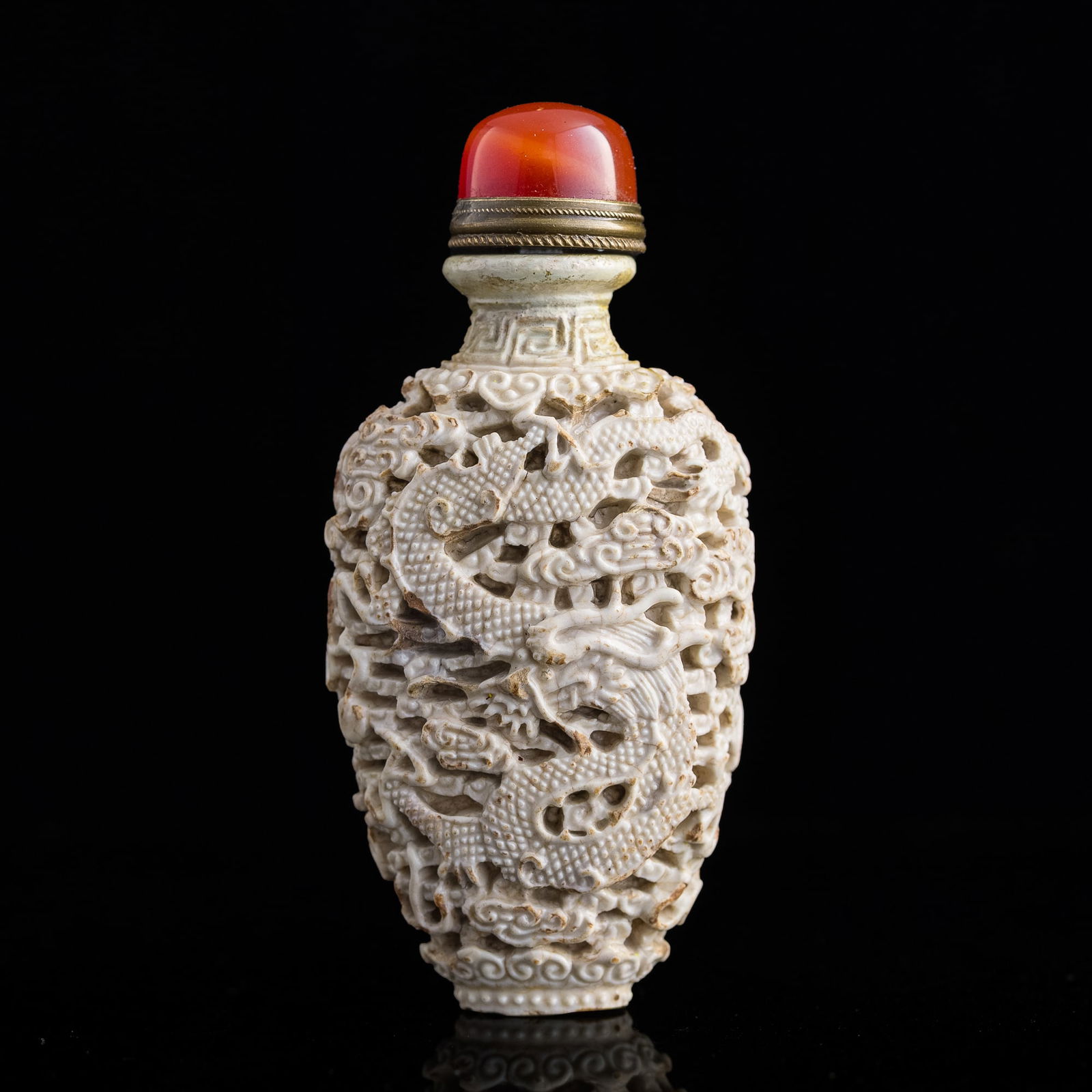 A Chinese white-glazed carved 'dragon and phoenix' snuff bottle, early 19th century (1 of 7)