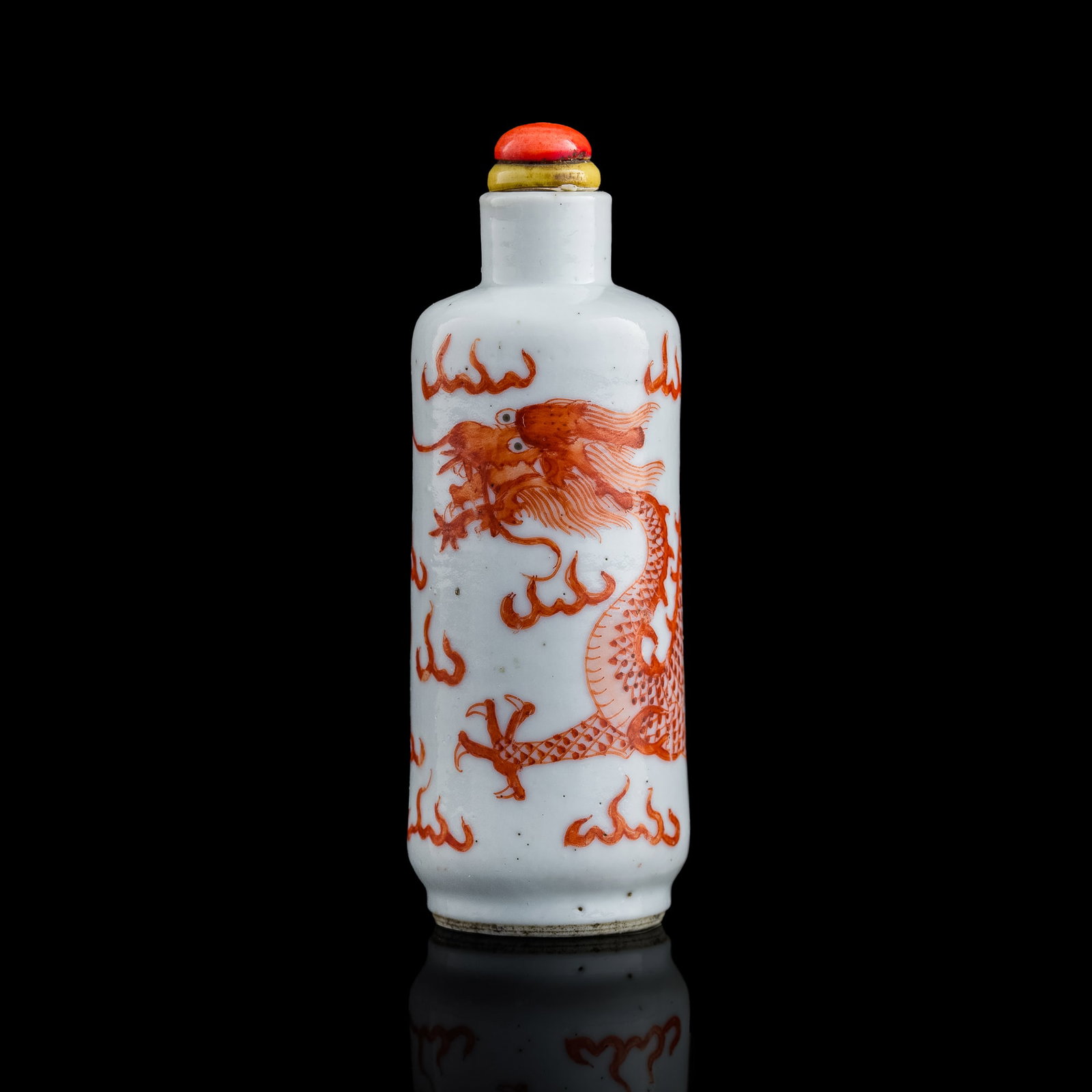A Chinese iron-red 'dragon' snuff bottle, 19th century: A Chinese iron-red 'dragon' snuff bottle 19th century With four-character mark to underside. H: 3 1/4, Dia: 1 1/4 in. (H: 8.26, Dia: 3.18 cm.) Provenance: Private collection, Cleveland, Ohio. The item