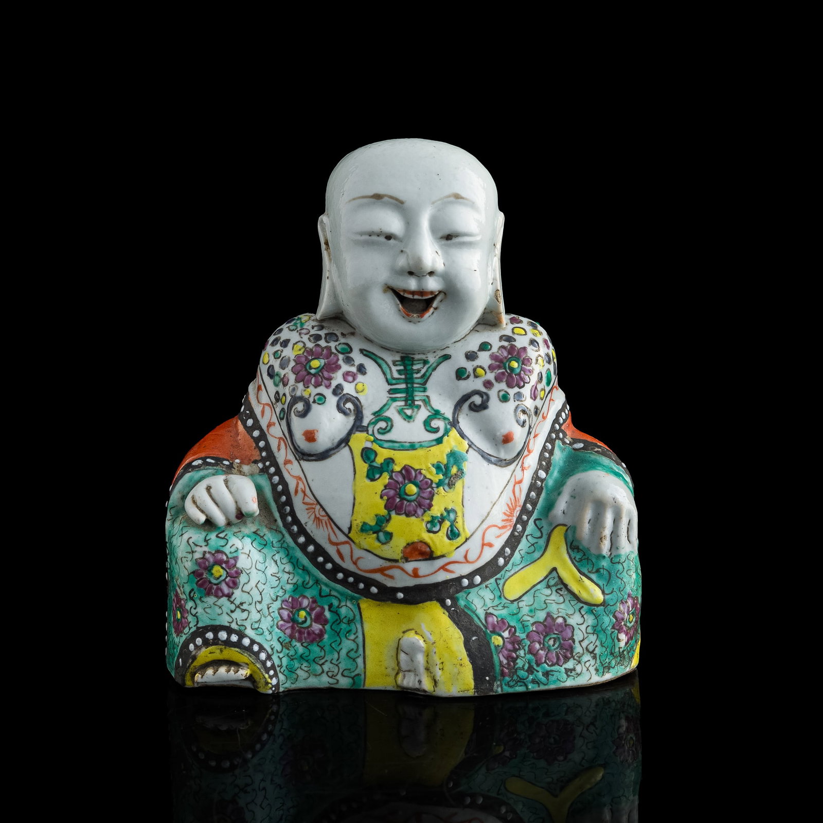 A Chinese famille rose Buddha figure, 18th century: A Chinese famille rose Buddha figure 18th century With previous dealer's sticker to verso. H: 6 7/8, W: 6 1/4, D: 3 1/8 in. (H: 17.46, W: 15.88, D: 7.94 cm.) Provenance: From Mrs. Chang, La Jolla, Cal