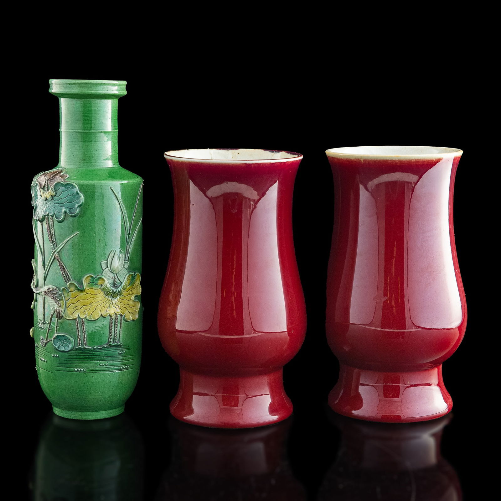 A pair of Chinese red-glazed vases and a sancai-glazed rouleau vase, 19th century (1 of 11)