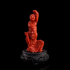 A Chinese carved coral elderly scholar and boy, Republic period