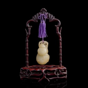 A Chinese carved white jade 'double gourd' toggle, 19th century