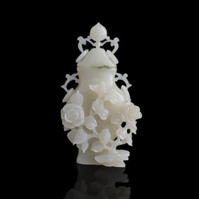 A Chinese white jade 'floral' lidded vase, early 20th century