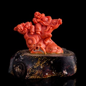 A Chinese carved coral boy