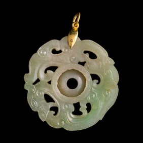 A Chinese pierced rotating jadeite plaque, 19th century