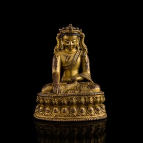 A Tibetan gilt-copper alloy Buddha, 14th century