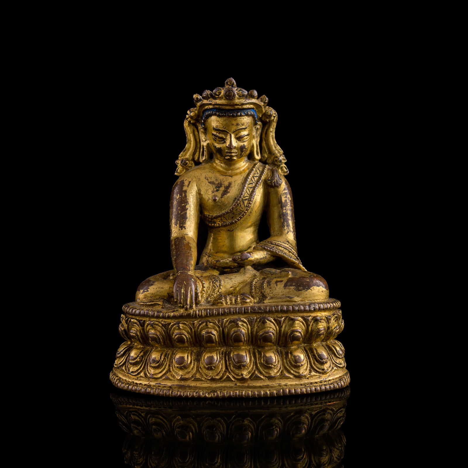 A Tibetan gilt-copper alloy Buddha, 14th century (1 of 8)