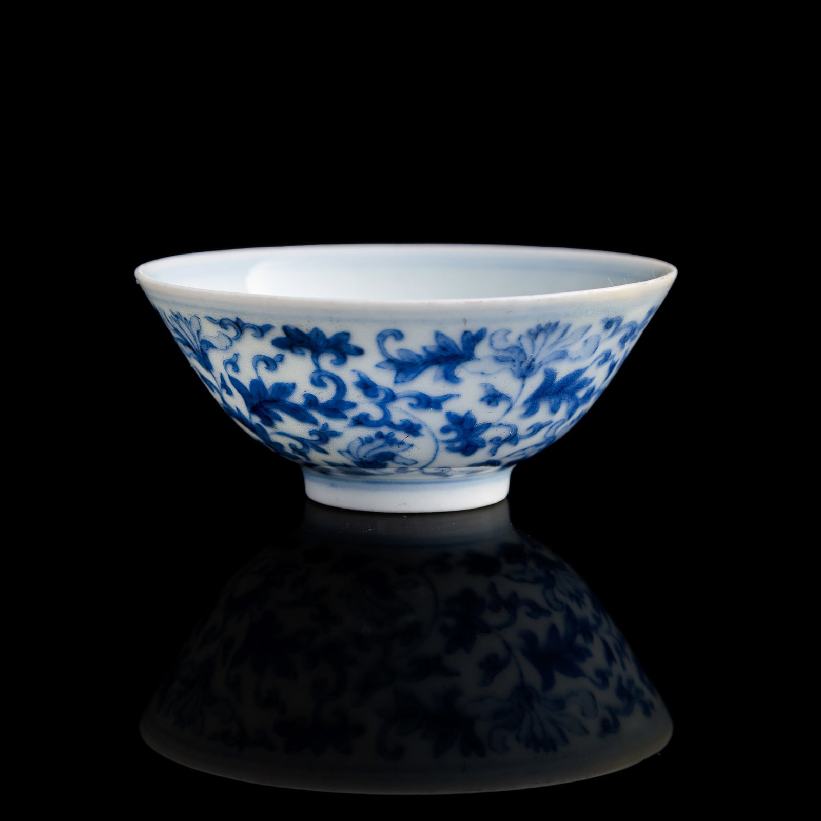 A Chinese blue and white 'scrolling flower' cup, Yongzheng period, Qing dynasty (1 of 8)