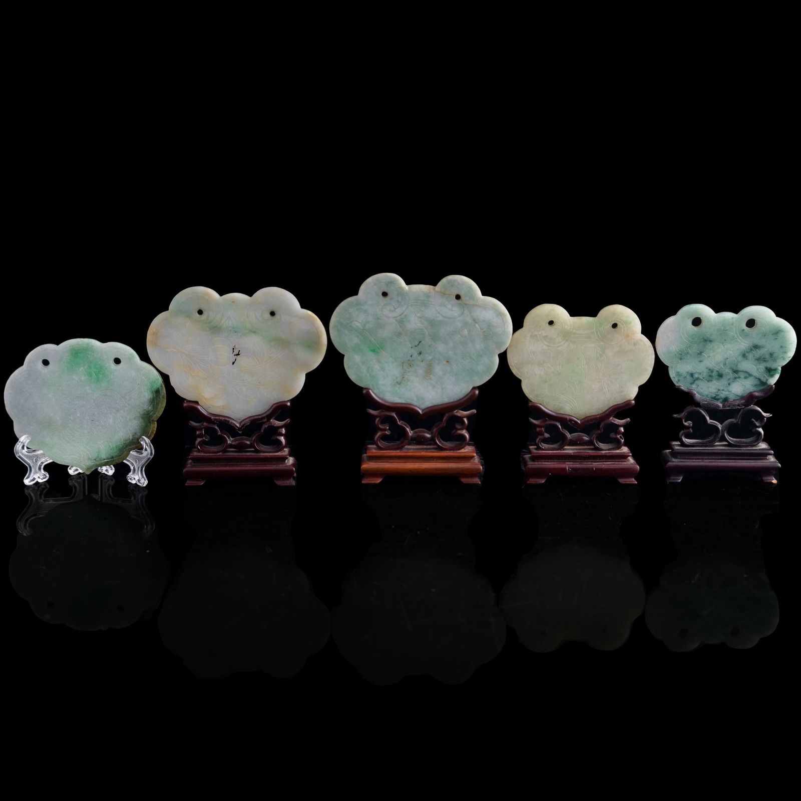 Five Chinese jadeite lockplates, 19th century: Five Chinese jadeite lockplates 19th century Sold with four associated stands. (5). H: 2 7/8, W: 4 1/4, D: 1/8 in. (H: 7.30, W: 10.80, D: 0.32 cm. (largest)) Collection of Mrs. Hastings, Baltimore, Ma