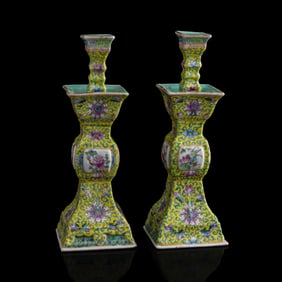 A pair of Chinese yellow-ground famille rose candlesticks, Republic period