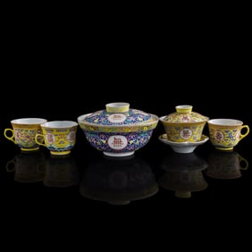 Four Chinese yellow-ground famille rose cups and a bowl, Guangxu period, Qing dynasty