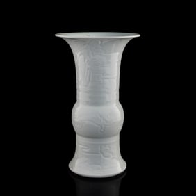 A Chinese white-glazed anhua 'dragon' gu vase, 19th century
