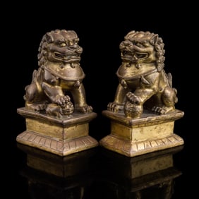 A pair of small Chinese gilt-bronze guardian lions, 18th/19th century