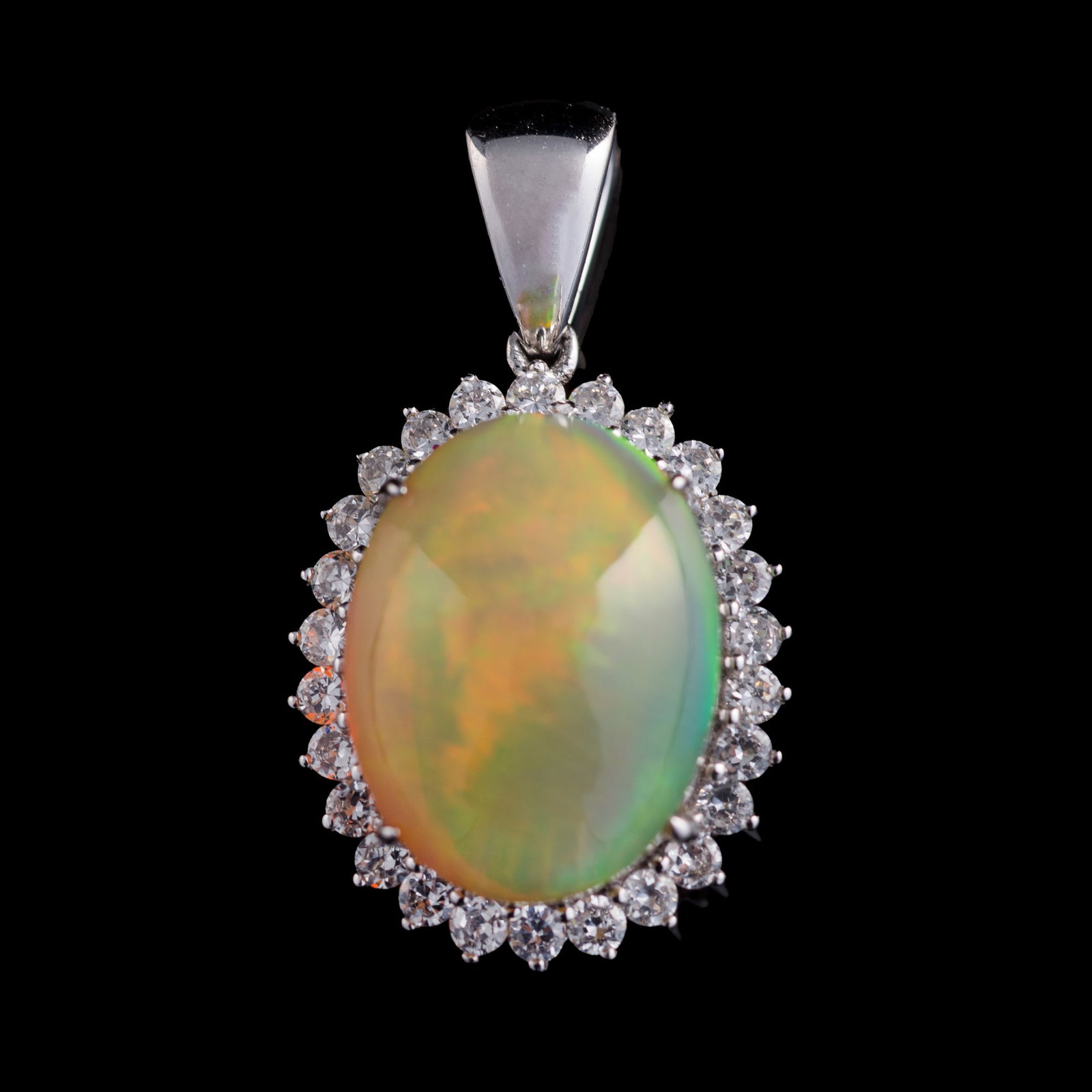 An opal and diamond pendant: An opal and diamond pendant Pendant marked "AU585 F 4.187ct". H: 1 1/8, W: 5/8, D: 1/2 in. (H: 2.86, W: 1.59, D: 1.27 cm. (opal)) Weight: 3.52 dwt (approximately) Private collection, Rosedale, Marylan