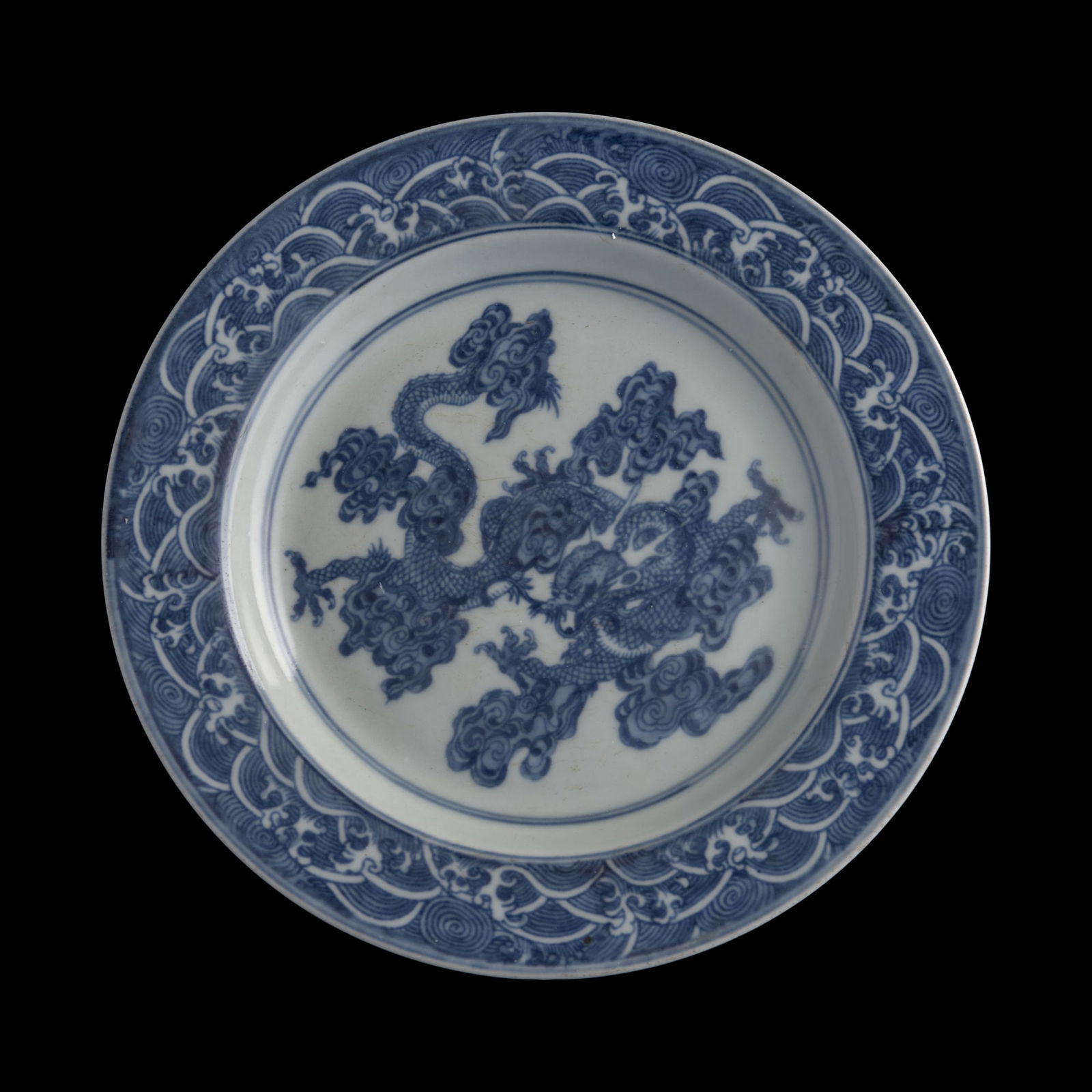 A Chinese blue and white 'dragon' plate, Qing dynasty (1 of 5)
