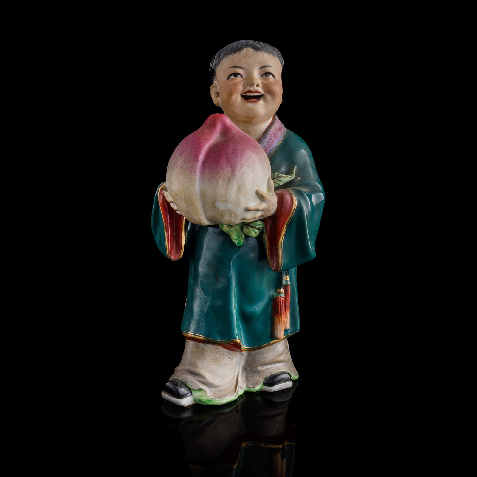 A Chinese famille rose porcelain boy, 1950s-1960s: A Chinese famille rose porcelain boy 1950s-1960s H: 9 1/4, W: 4, D: 4 1/4 in. (H: 23.50, W: 10.16, D: 10.80 cm.) Private collection, Howell, New Jersey.