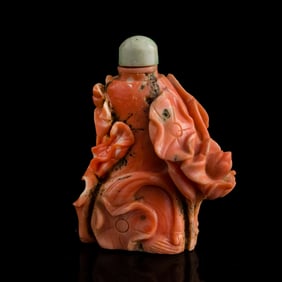 A Chinese carved coral 'lotus pond' snuff bottle, 19th century