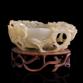 A Chinese carved lotus-form jade washer, Ming dynasty