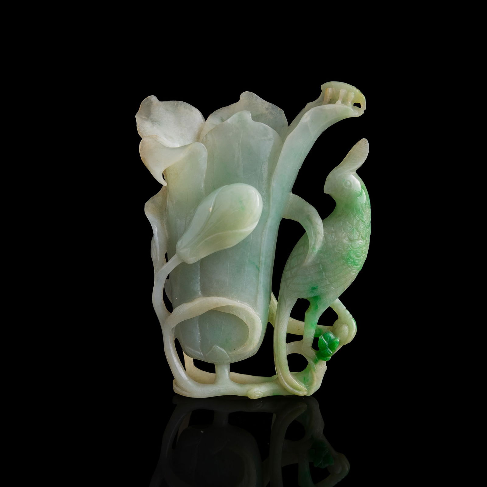A Chinese carved jadeite flower holder, 19th century: A Chinese carved jadeite flower holder 19th century Carved in the form of a lotus flower beside a bird perched on lotus leaves. H: 3 5/8, W: 2 3/4, D: 1 1/4 in. (H: 9.21, W: 6.99, D: 3.18 cm.) Private