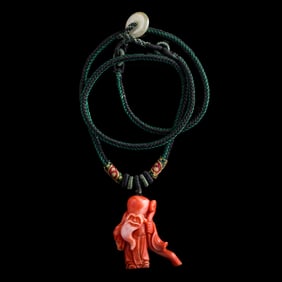 A Chinese coral pendant of Shou