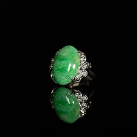 A Chinese white gold ring with jadeite cabochon and diamonds
