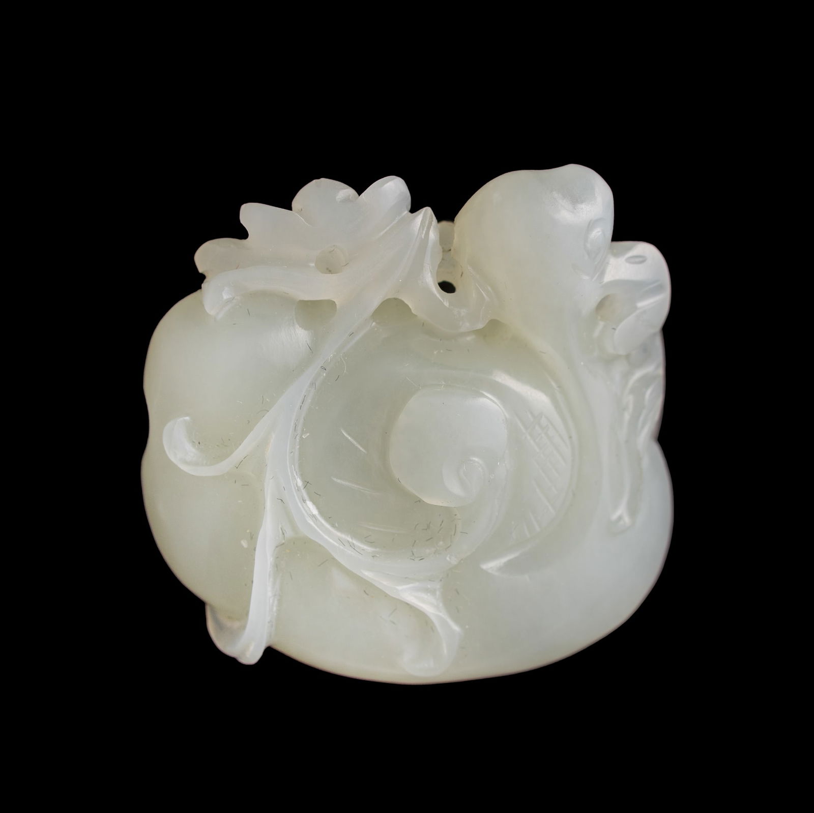 A Chinese carved white jade pendant of mandarin duck, 19th century: A Chinese carved white jade pendant of mandarin duck 19th century Depicting a mandarin duck holding a lotus spray in its beak. H: 1 1/2, W: 1 5/8, D: 5/8 in. (H: 3.81, W: 4.13, D: 1.59 cm.) Private co