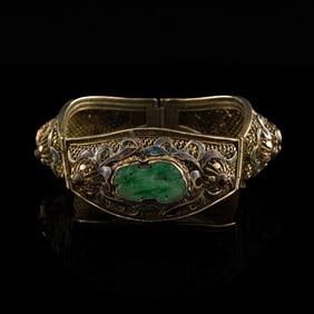 A Chinese silver-enameled bangle inset with three jadeite guardian lion plaques