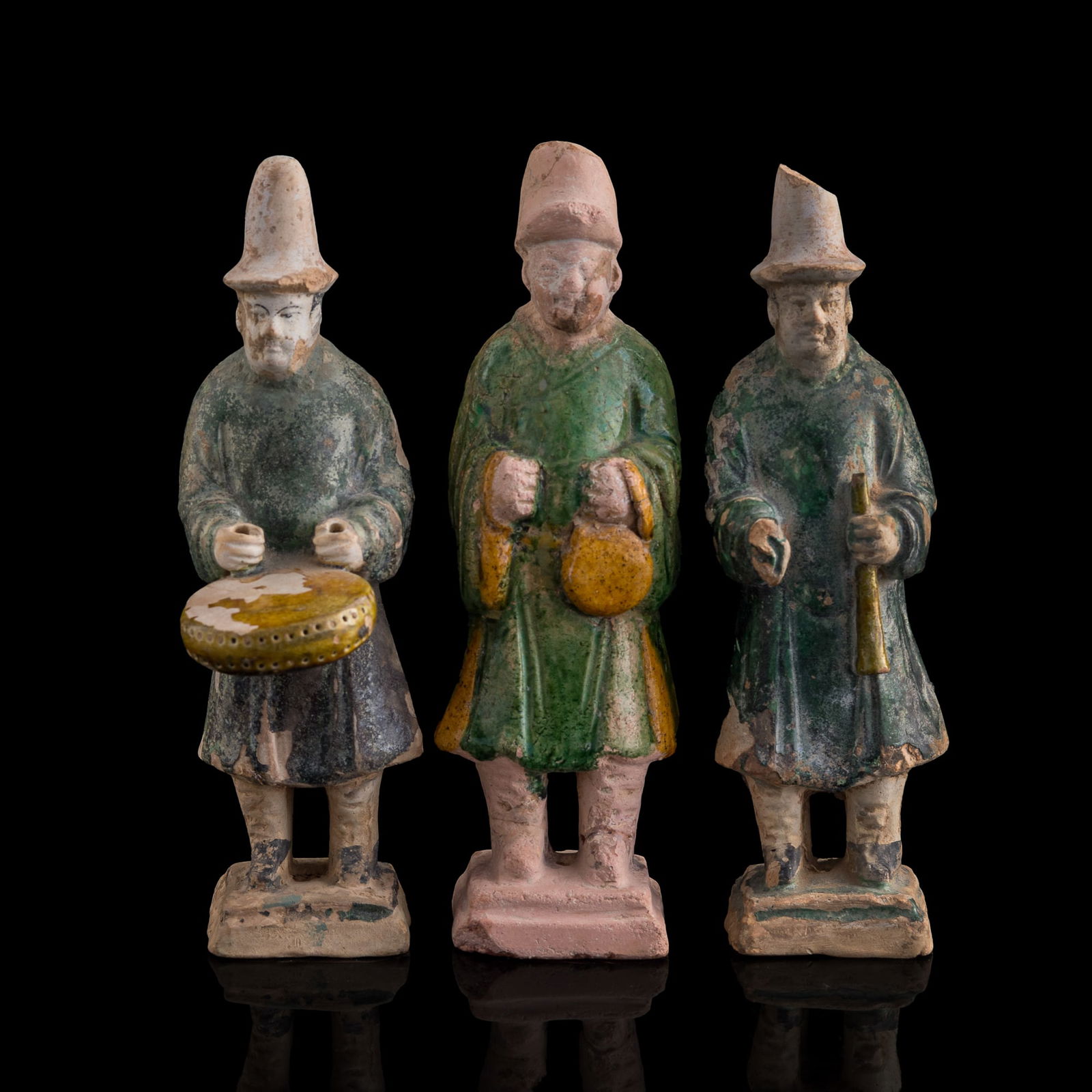 Three Chinese sancai pottery figures, Ming dynasty: Three Chinese sancai pottery figures Ming dynasty Each figure is holding a musical instrument. (3). H: 7 5/8, W: 2 1/2, D: 2 in. (H: 19.37, W: 6.35, D: 5.08 cm. (tallest)) Private estate, Palm Springs