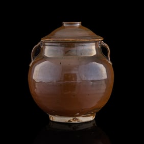 A Chinese persimmon-glazed double-handle lidded jar, possibly Yuan dynasty