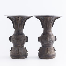 A pair of Chinese bronze gu vases, 18th century