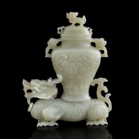 A Chinese carved jade qilin carrying vase
