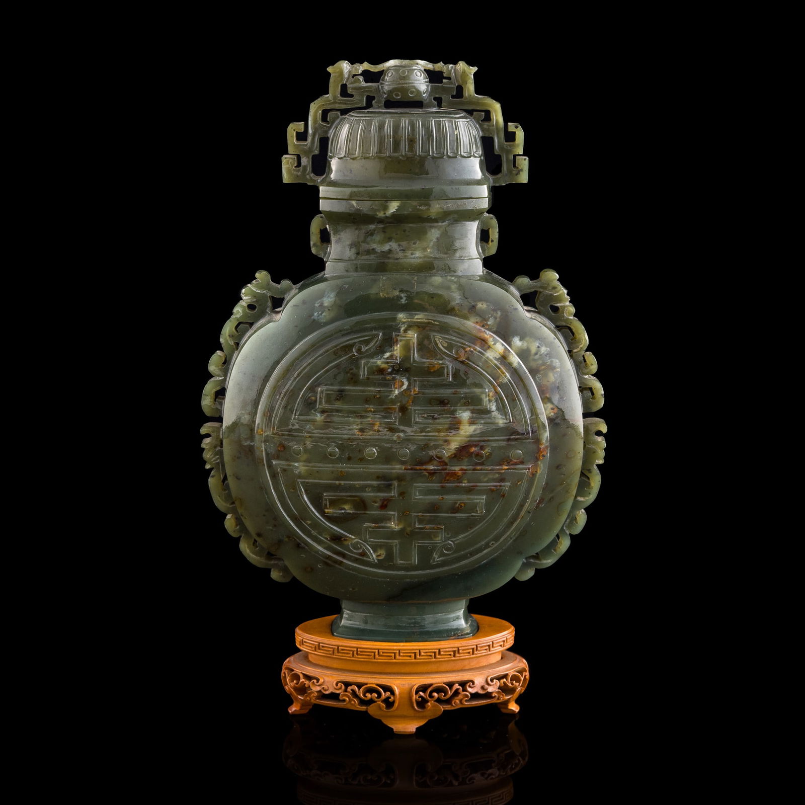 A Chinese celadon jade lidded vase: A Chinese celadon jade lidded vase Sold with associated wooden stand. H: 8 7/8, W: 6, D: 2 3/8 in. (H: 22.54, W: 15.24, D: 6.03 cm.) From a Florida private collection, assembled by a seasoned collecto