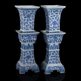 A pair of Chinese blue and white 'scrolling flower' candlesticks, early 19th century