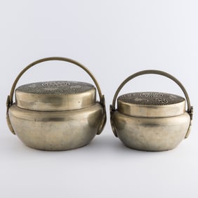 Two Chinese Paktong hand warmers, late 19th century