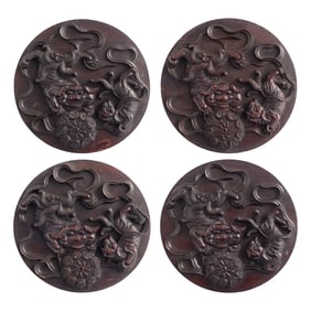 Four Chinese carved hardwood 'lion' roundel plaques, 19th century