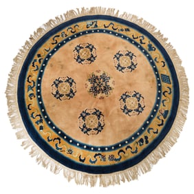 A Chinese round apricot yellow-ground rug, Republic period