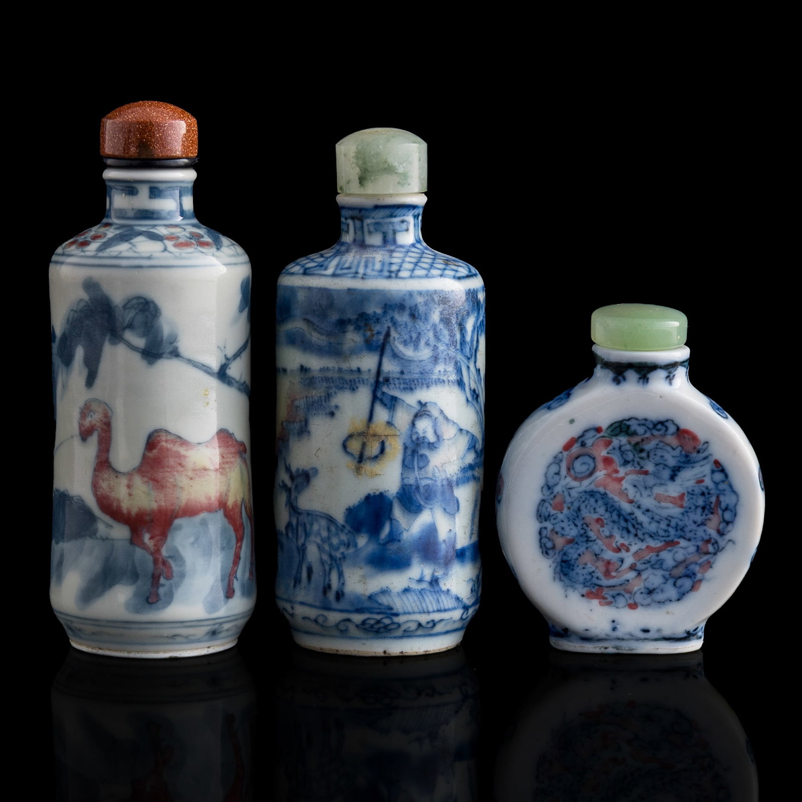 Three Chinese porcelain snuff bottles, 19th century: Three Chinese porcelain snuff bottles 19th century With two blue and copper-red-underglazed snuff bottles and one blue and enamel snuff bottle. (3). H: 3 3/8, Dia: 1 1/2 in. (H: 8.57, Dia: 3.81 cm. (l