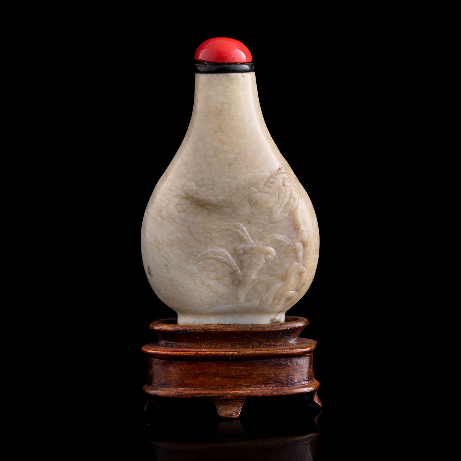 A Chinese carved jade 'bat' and 'lingzhi' snuff bottle, 18th century: A Chinese carved jade 'bat' and 'lingzhi' snuff bottle 18th century Sold with associated stand. H: 2, W: 1 3/8, D: 5/8 in. (H: 5.08, W: 3.49, D: 1.59 cm.) Collection of Mr. Kleeman, Boston, Massachuse