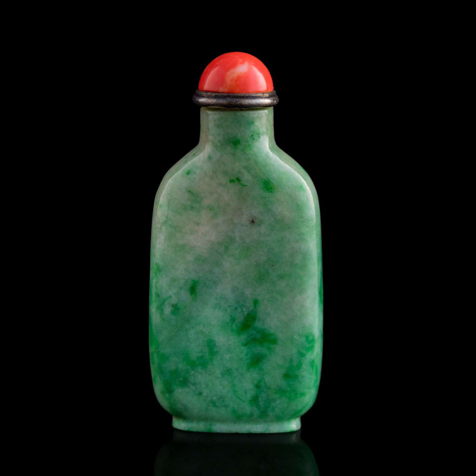 A Chinese jadeite snuff bottle, 19th century: A Chinese jadeite snuff bottle 19th century Carved from green jadeite with soft mottling. Sold with a coral stopper. H: 2 1/2, W: 1 3/8 in. (H: 6.35, W: 3.49 cm.) Private collection, New Jersey.