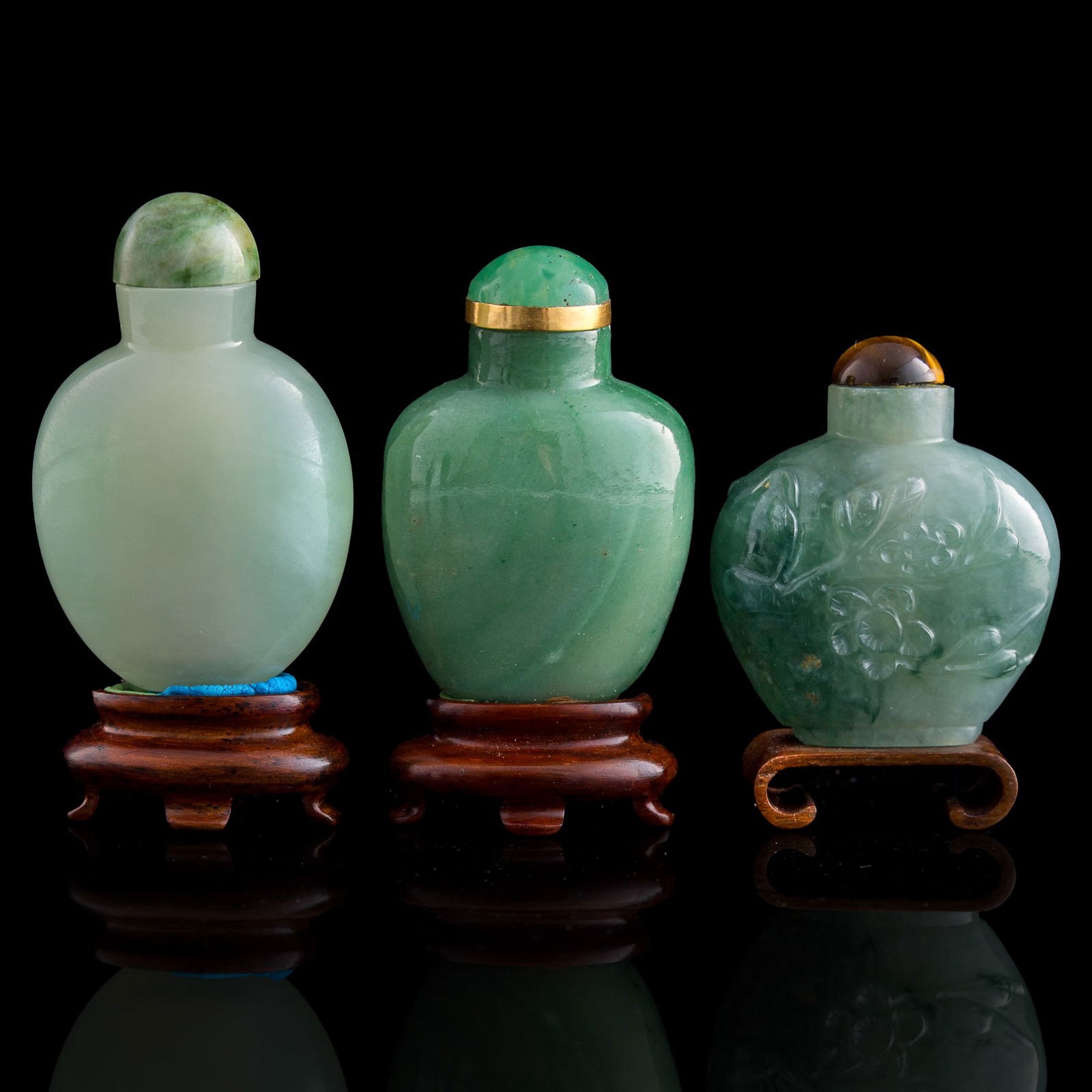 Three Chinese jadeite snuff bottles, 19th century: Three Chinese jadeite snuff bottles 19th century Sold with three associated stands. (3). H: 2 1/4, W: 1 5/8, D: 7/8 in. (H: 5.72, W: 4.13, D: 2.22 cm. (largest)) Collection of Mr. Kleeman, Boston, Mas