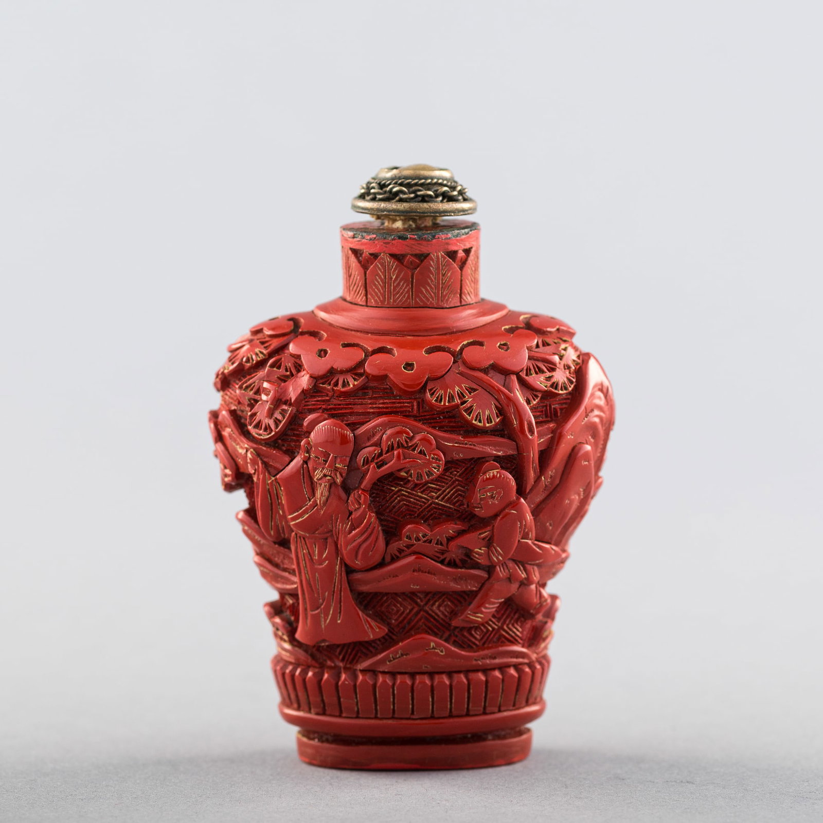 A Chinese carved cinnabar 'figural' snuff bottle, 19th century: A Chinese carved cinnabar 'figural' snuff bottle 19th century H: 2 5/8, W: 2, D: 1 1/4 in. (H: 6.67, W: 5.08, D: 3.18 cm. (bottle)) From Mr. Yueh, Houston, Texas. A family heirloom.