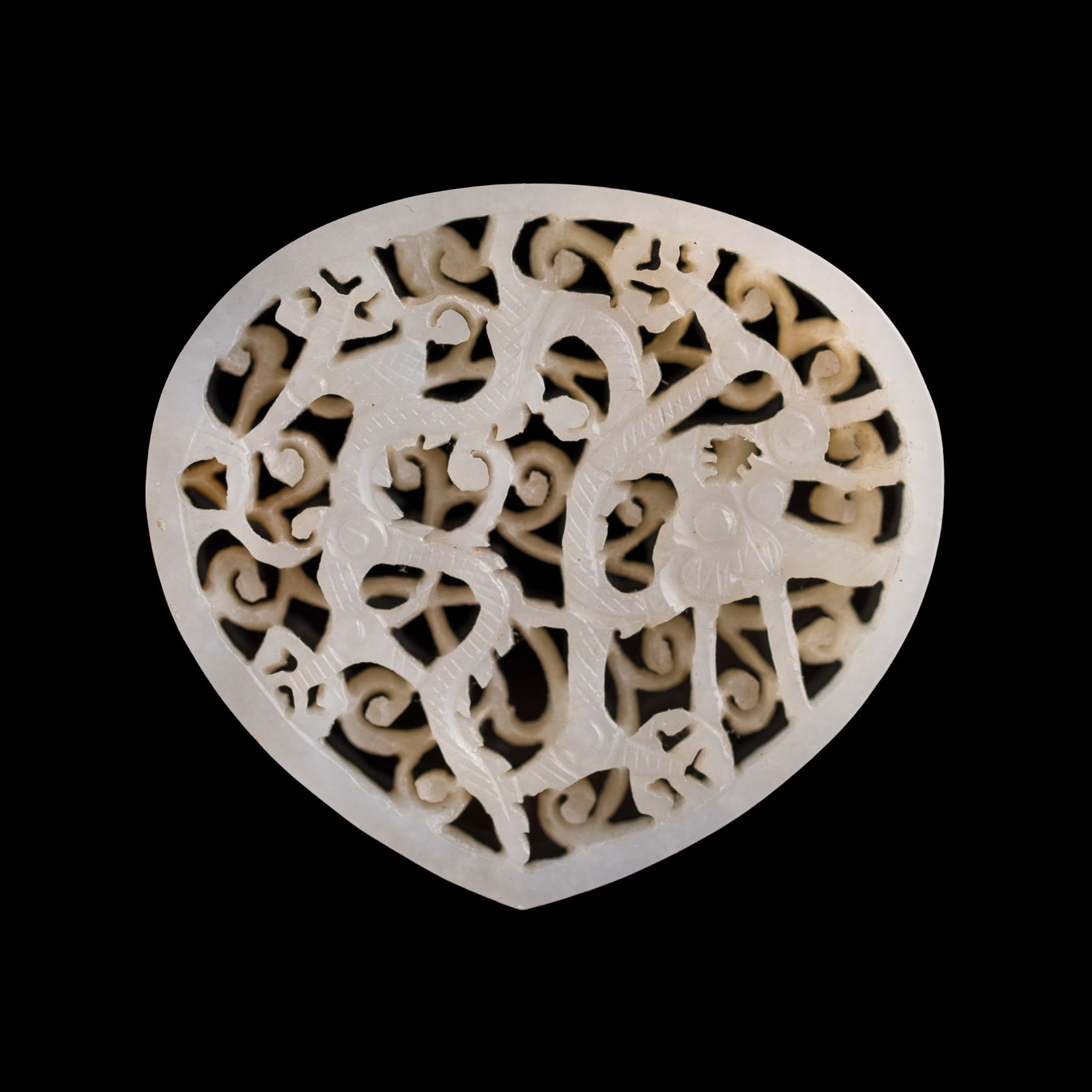 A Chinese reticulated white jade dragon belt plaque, Ming dynasty (1 of 5)